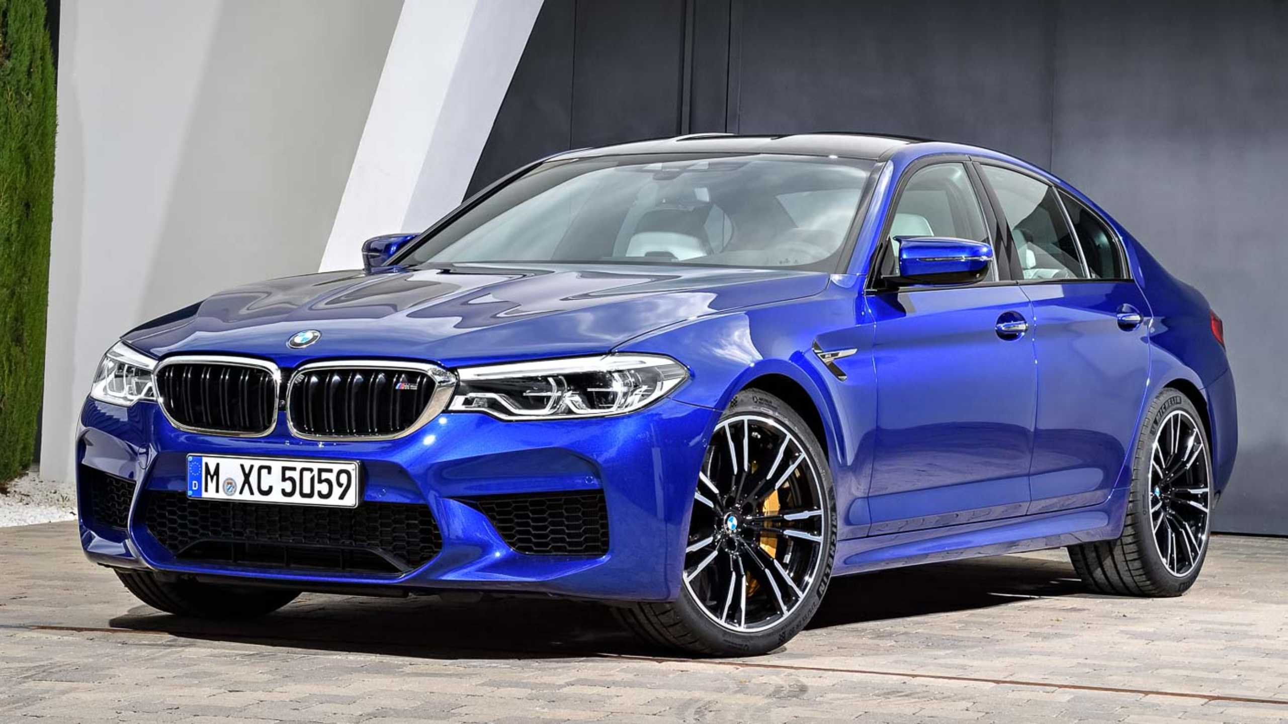 Blue BMW M5 parked outside our showroom